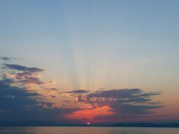 Low angle view of dramatic sky over sea during sunset