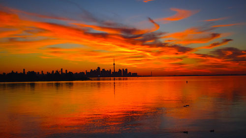 Scenic view of sea against orange sky