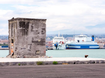 Cruise ship at harbor against sky