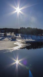 Sun shining through clouds over sea