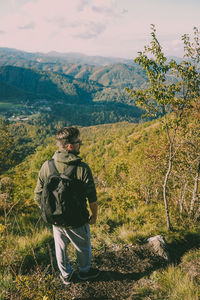 Rear view of man looking at mountains