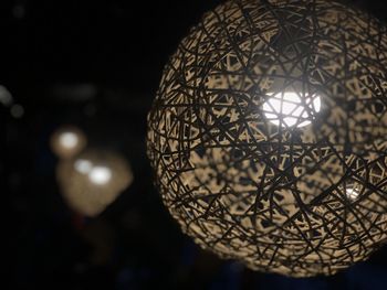 Low angle view of illuminated pendant lights hanging from ceiling