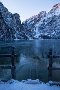 Scenic view of lake against sky during winter