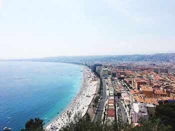 High angle view of sea and cityscape against sky