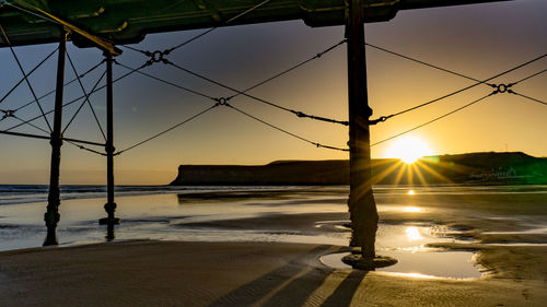 Scenic view of beach against sky during sunset