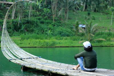 Rear view of man fishing in boat