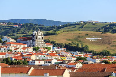 Buildings in town against clear sky