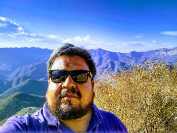 Portrait of man in mountains against sky