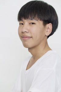 Portrait of smiling boy against white background