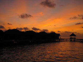 Scenic view of sea against orange sky