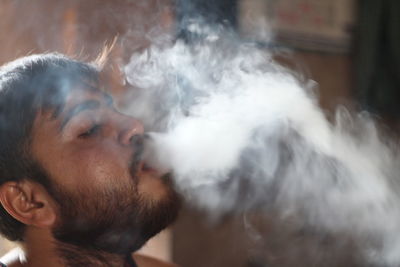 Close-up of young man smoking