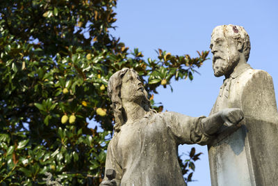 Low angle view of statue against sky