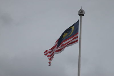 Low angle view of flag against sky