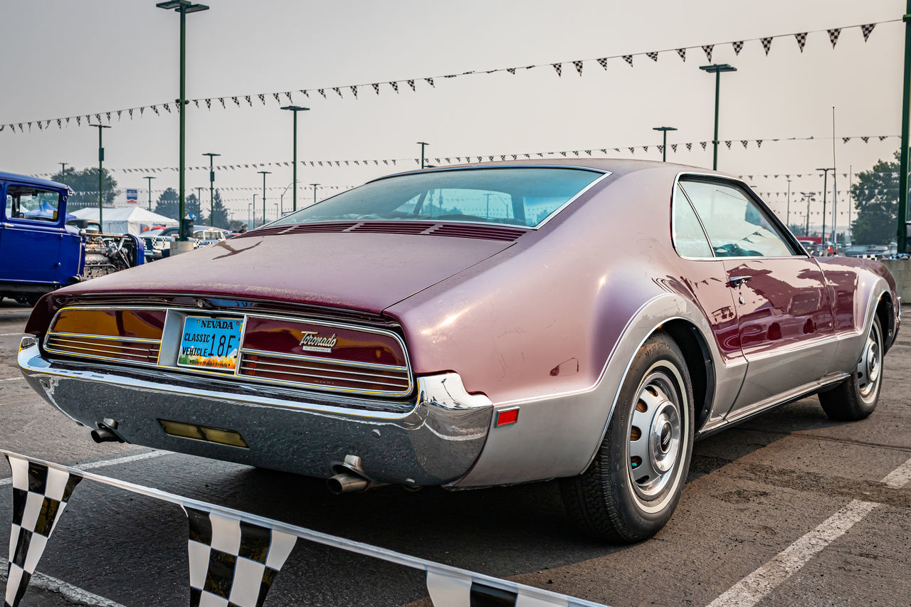 car, vehicle, land vehicle, mode of transportation, motor vehicle, transportation, sports car, road, city, street, architecture, muscle car, automotive exterior, automobile, performance car, retro styled, no people, sign, sky