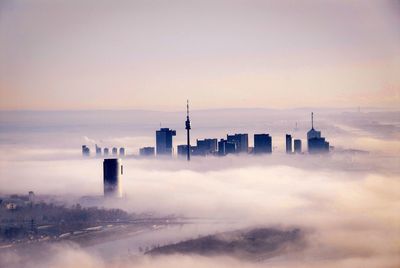 Scenic view of city and clouds