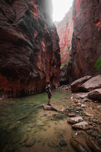 Man surfing on rock by water