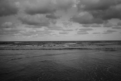 Scenic view of sea against cloudy sky