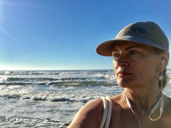 Portrait of man against sea against clear blue sky