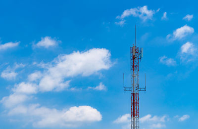 Telecommunication tower with blue sky and white clouds background. antenna on blue sky. 