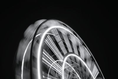 Blurred motion of ferris wheel at night