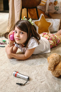 High angle view of girl playing with teddy bear