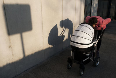 Mother with baby carriage in the street