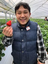 Portrait of a smiling young man standing outdoors