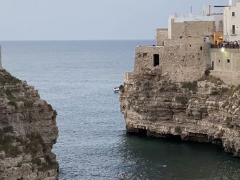 Scenic view of sea and buildings against sky