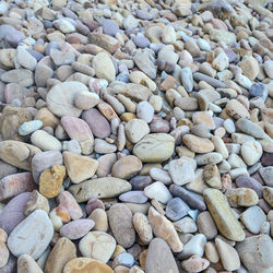 Close up of rounded and polished beach rocks on the sea shore