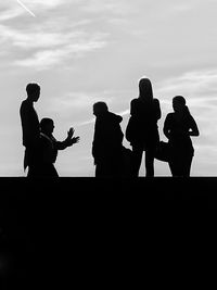 Silhouette of people against sky