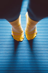 Low section of person wearing socks tip-toe standing on floor