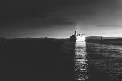 Silhouette ship in sea against sky