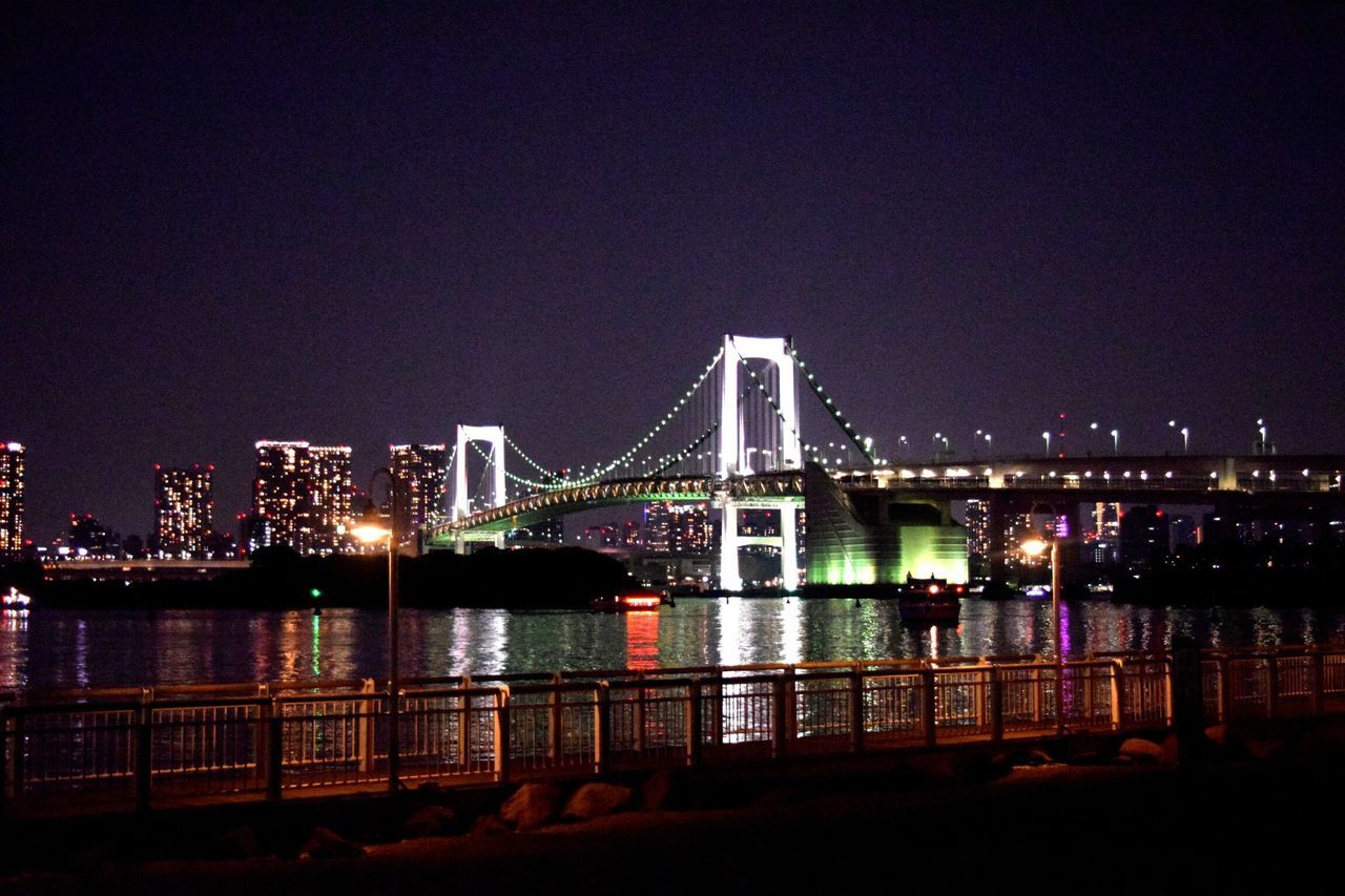 night, illuminated, architecture, built structure, city, bridge - man made structure, building exterior, connection, river, copy space, suspension bridge, engineering, cityscape, clear sky, water, bridge, sky, modern, development, dark