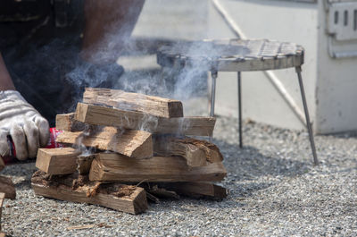 Cropped image of person burning firewood