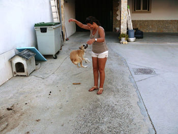 Full length of woman with dog