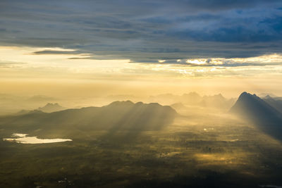 Aerial view of landscape against dramatic sky during sunset