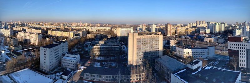 High angle view of city buildings against clear sky