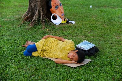 Girl lying on grassy field