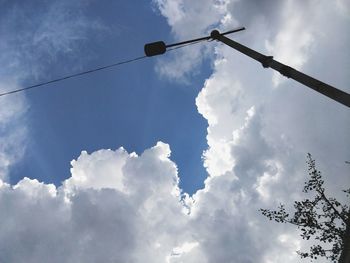 Low angle view of street light against cloudy sky