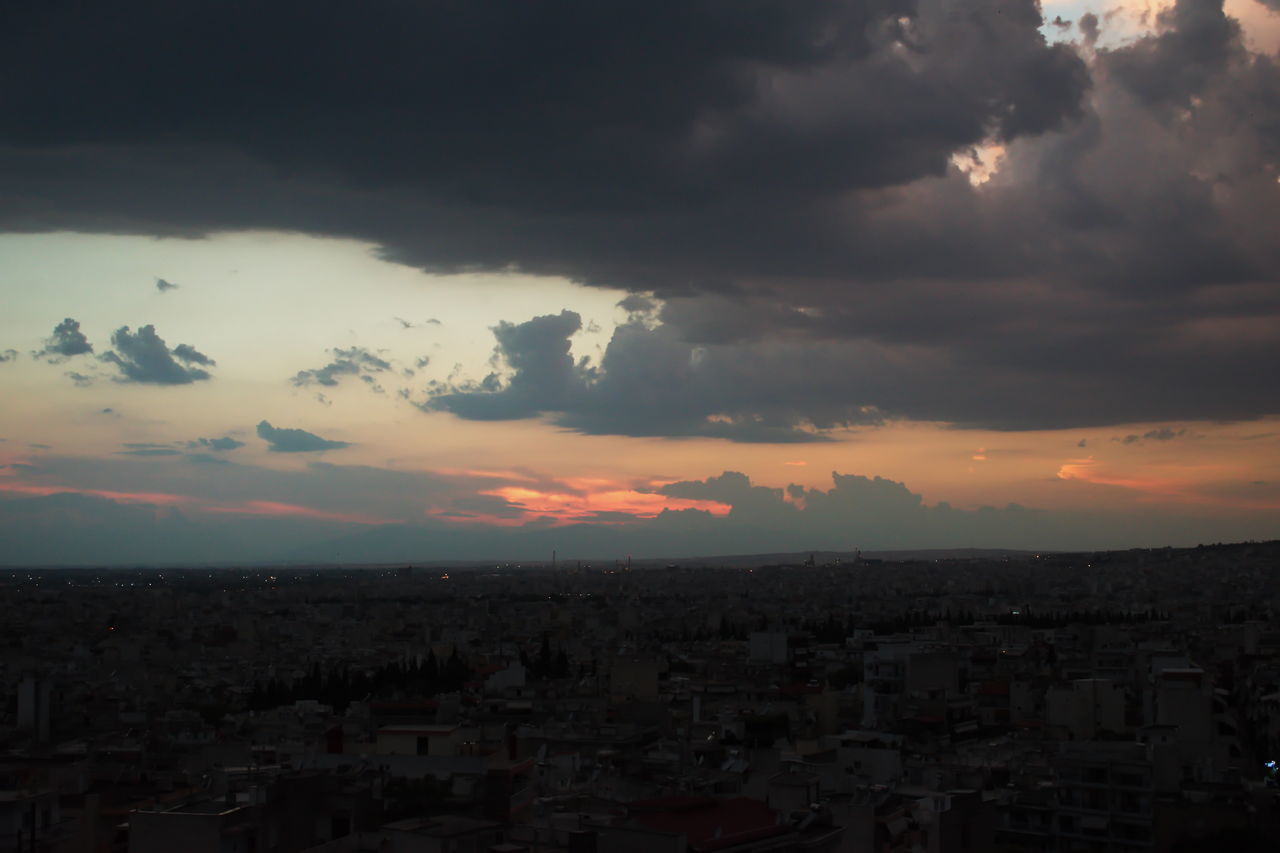 AERIAL VIEW OF TOWNSCAPE AGAINST DRAMATIC SKY