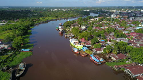 High angle view of townscape by river in city