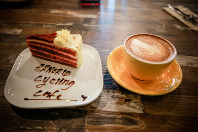 Coffee cup and cake on table