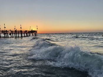 Scenic view of sea against clear sky during sunset