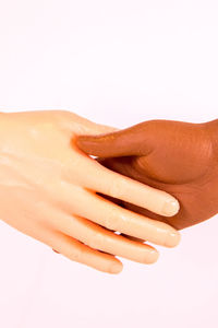 Close-up of hands over white background