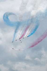 Low angle view of airshow against sky