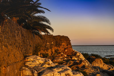 Scenic view of sea against sky at sunset