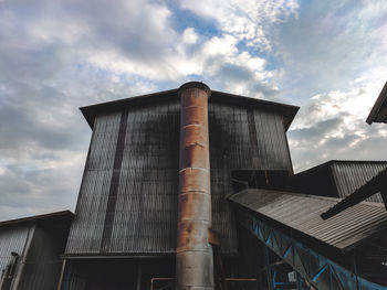 Low angle view of factory against sky