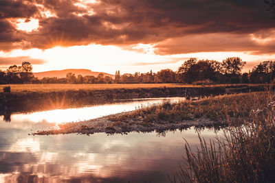 Scenic view of lake against sky during sunset