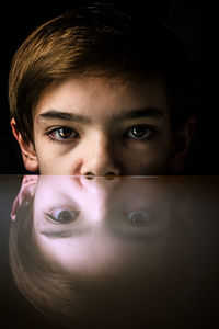 Close-up portrait of teenage boy at table