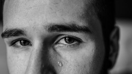 Cropped image of man crying